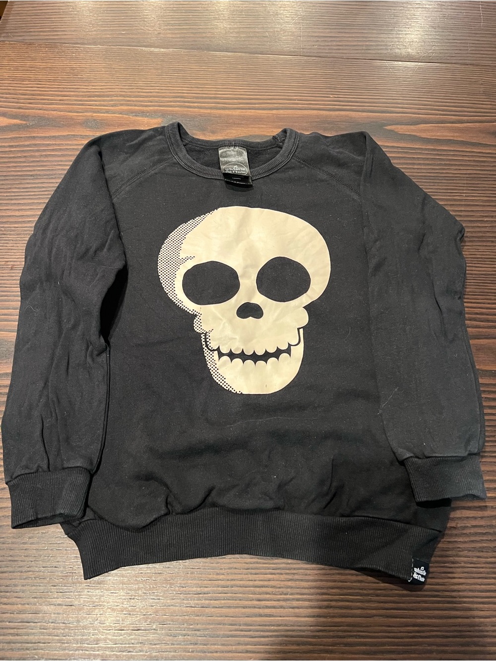 Black Crewneck Sweatshirt with Glow-In-The-Dark Cream Skull Graphic